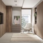 Dormitorio con armarios de madera hasta el techo, cómoda, butaca y televisión empotrada